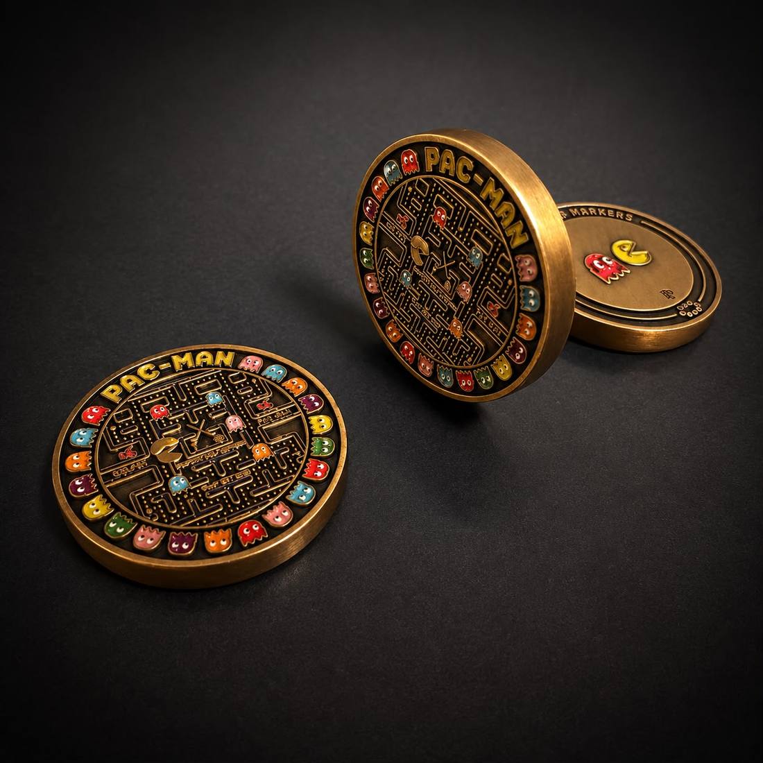 Two Pac-Man markers on a dark surface, one standing to show the back